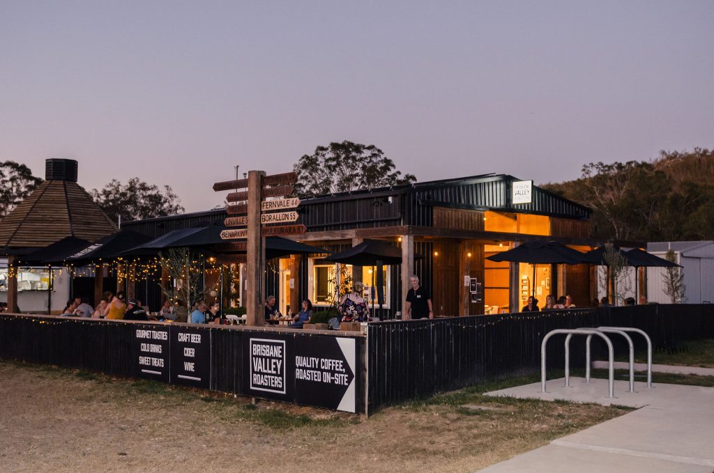 Picture of an industrial look cafe outdoor are, at dusk with festoon lights